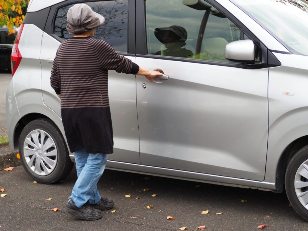 軽自動車に乗り込む高齢者