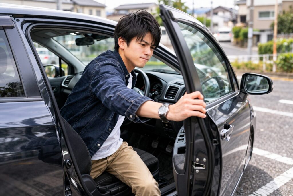 若い男が自動車から降りてドアを強く閉める